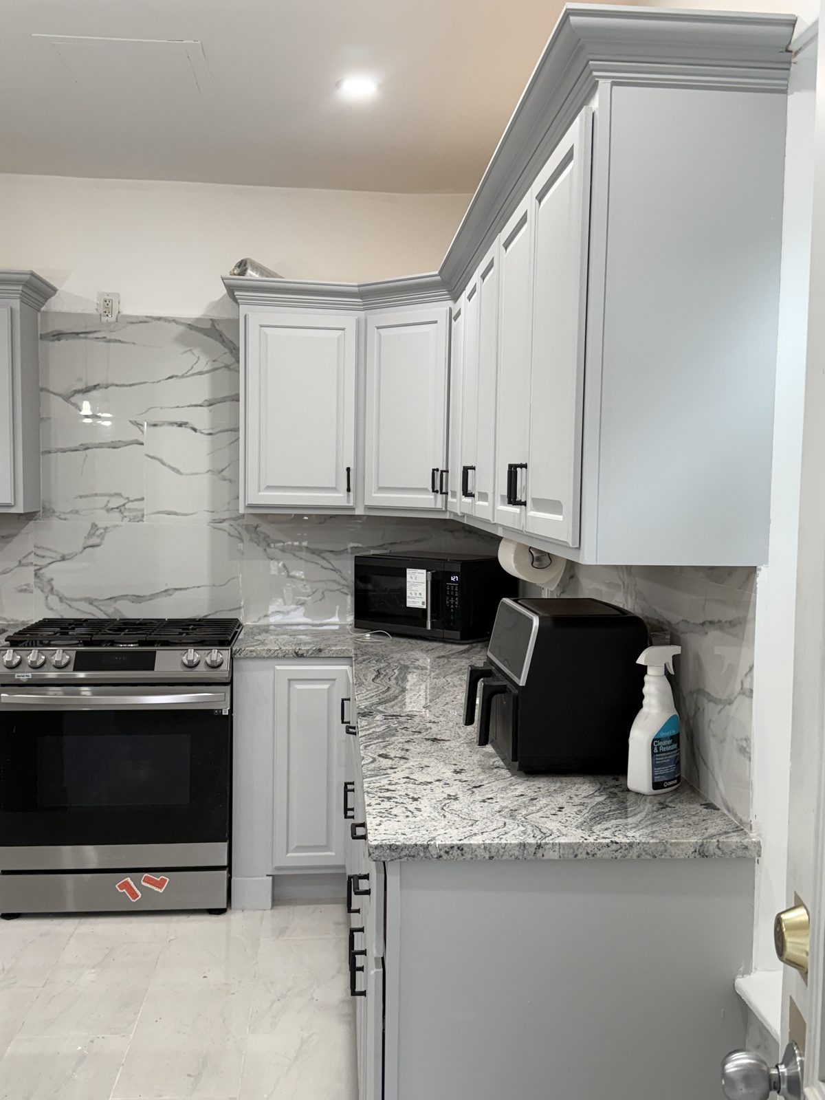 Kitchen with marble backsplash and granite countertops